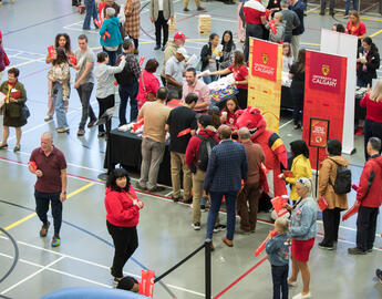 An aerial shot of people standing around a merchandise table
