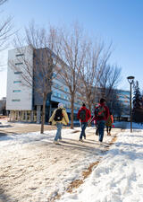 Photot of people walking on campus in the snow 